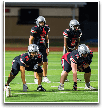 Three football players are standing on the field, one of them is smiling and wearing a black jersey with the number 55. AI generated content
