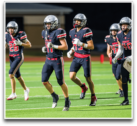 Three football players are standing on the field, one of them is smiling and wearing a black jersey with the number 55. AI generated content