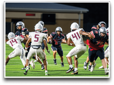 Three football players are standing on the field, one of them is smiling and wearing a black jersey with the number 55. AI generated content