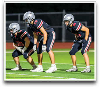 Three football players are standing on the field, one of them is smiling and wearing a black jersey with the number 55. AI generated content