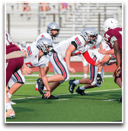 Three football players are standing on the field, one of them is smiling and wearing a black jersey with the number 55. AI generated content