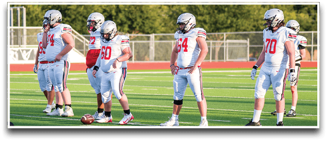 Three football players are standing on the field, one of them is smiling and wearing a black jersey with the number 55. AI generated content