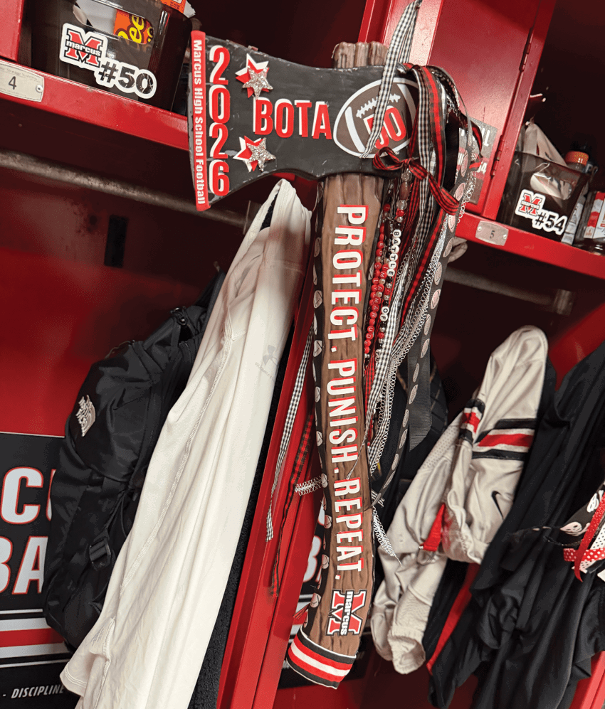 A hockey stick with the words “Protect, Punish, Repeat" is placed inside a red locker along with folded sports clothing and gear. Description generated by AI