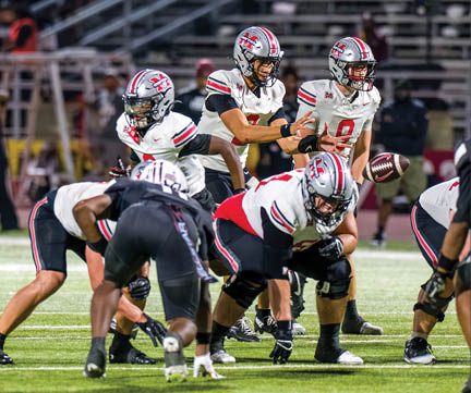 Three football players are standing on the field, one of them is smiling and wearing a black jersey with the number 55. AI generated content