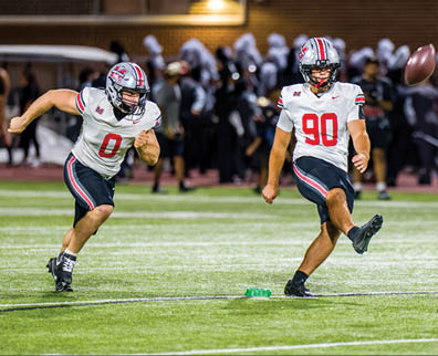 Three football players are standing on the field, one of them is smiling and wearing a black jersey with the number 55. AI generated content