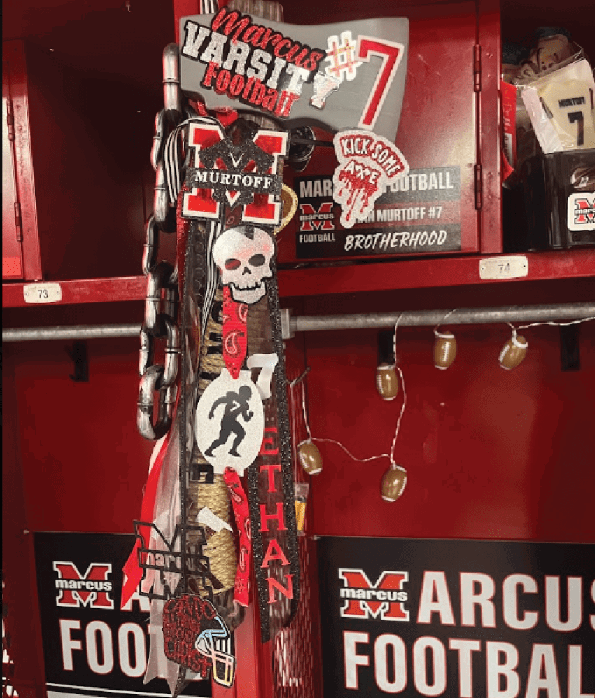 A red locker decorated with various football-themed patches and stickers including a skull, the name Murtoff, the number 7, and phrases like “Marcus Varsity Football" and "Kick Some." Description generated by AI