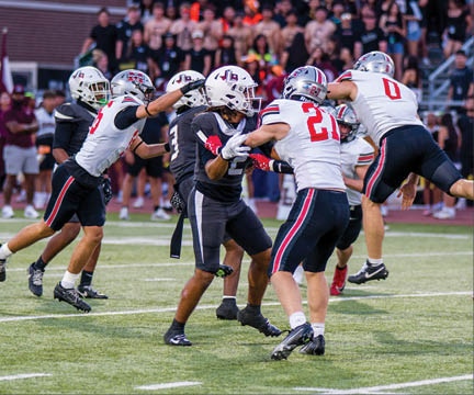 Three football players are standing on the field, one of them is smiling and wearing a black jersey with the number 55. AI generated content
