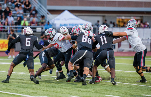 Three football players are standing on the field, one of them is smiling and wearing a black jersey with the number 55. AI generated content