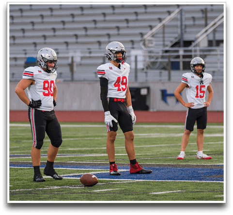 Three football players are standing on the field, one of them is smiling and wearing a black jersey with the number 55. AI generated content