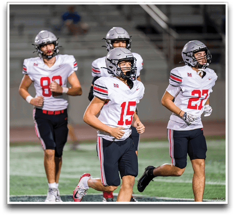 Three football players are standing on the field, one of them is smiling and wearing a black jersey with the number 55. AI generated content