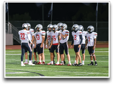 Three football players are standing on the field, one of them is smiling and wearing a black jersey with the number 55. AI generated content