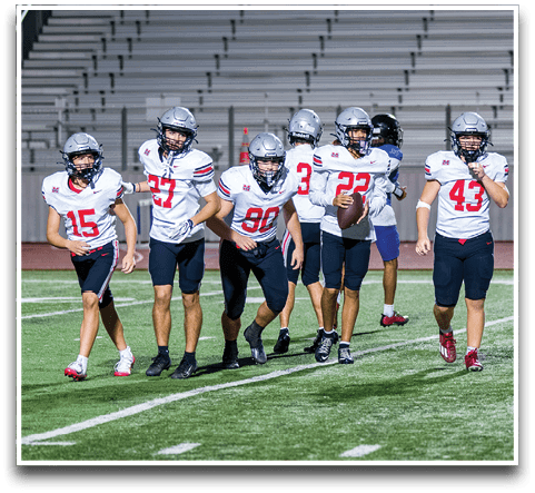 Three football players are standing on the field, one of them is smiling and wearing a black jersey with the number 55. AI generated content