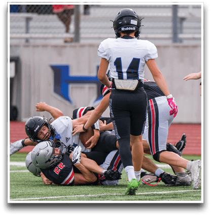 Three football players are standing on the field, one of them is smiling and wearing a black jersey with the number 55. AI generated content