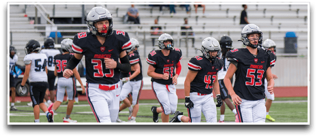 Three football players are standing on the field, one of them is smiling and wearing a black jersey with the number 55. AI generated content