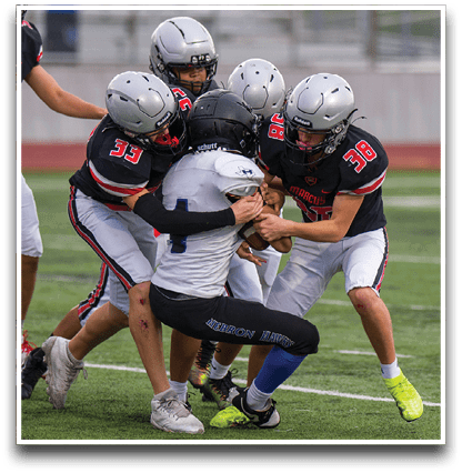 Three football players are standing on the field, one of them is smiling and wearing a black jersey with the number 55. AI generated content