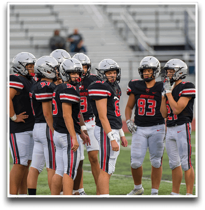 Three football players are standing on the field, one of them is smiling and wearing a black jersey with the number 55. AI generated content
