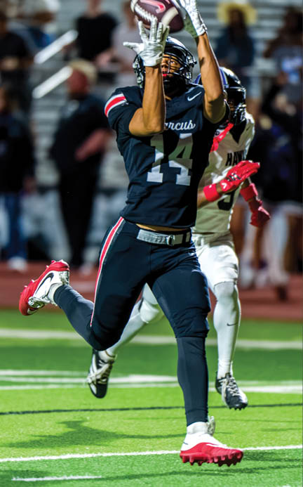 Three football players are standing on the field, one of them is smiling and wearing a black jersey with the number 55. AI generated content