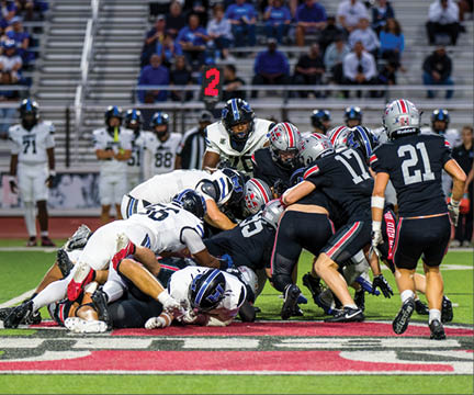 Three football players are standing on the field, one of them is smiling and wearing a black jersey with the number 55. AI generated content