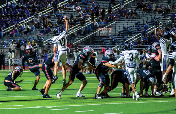 Three football players are standing on the field, one of them is smiling and wearing a black jersey with the number 55. AI generated content