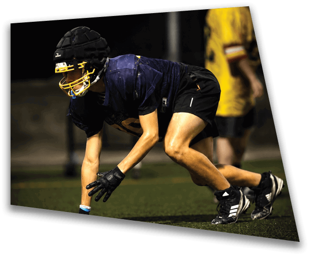A football player in a blue jersey is crouching on the field. AI generated content