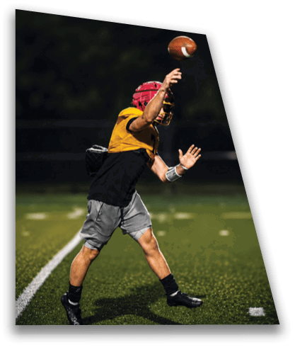 A man in a football uniform is throwing a football on a field. AI generated content