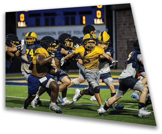 A group of football players in uniforms running on a field. AI generated content