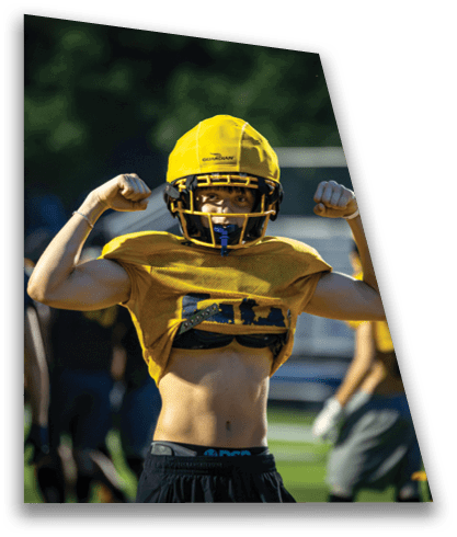 A football player poses with his shirt off and his arms flexed. AI generated content
