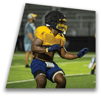 A group of football players on a field, one of them wearing a yellow jersey. AI generated content