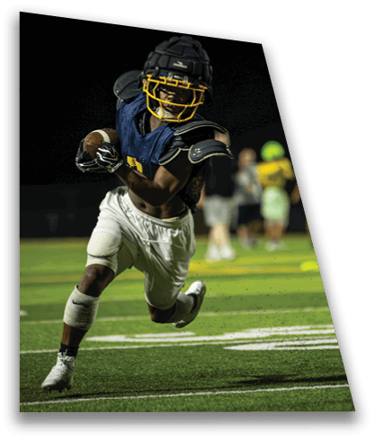 Two football players running on a field, one wearing a blue jersey and the other wearing a yellow jersey. AI generated content