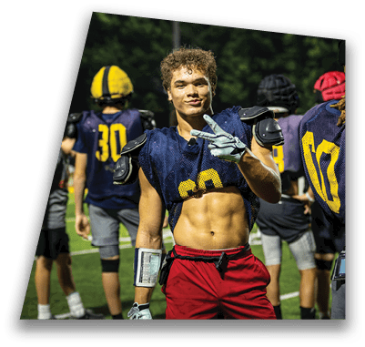 A man wearing a football uniform is posing for a picture. AI generated content