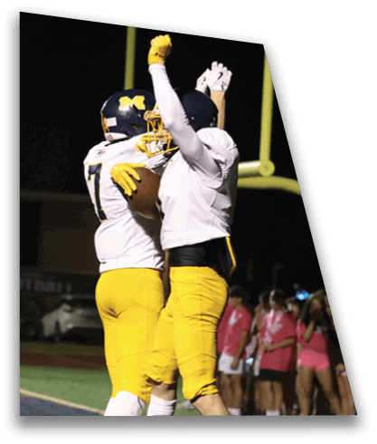 Two football players celebrating a touchdown by jumping in the air. AI generated content