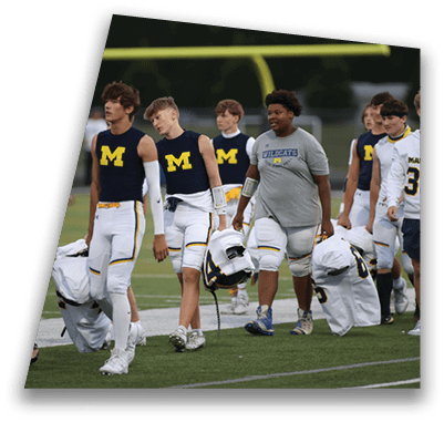 A group of young men wearing blue and white uniforms are walking on a field. AI generated content