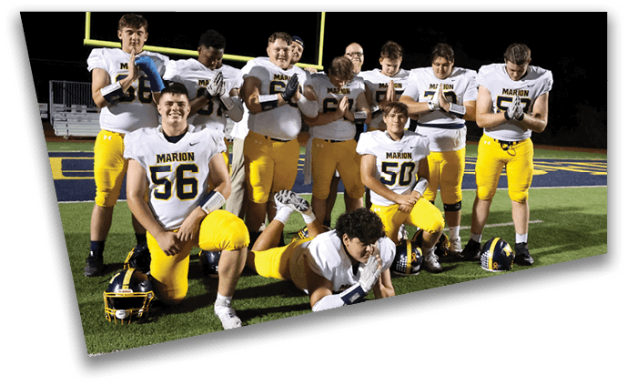A group of football players pose for a photo on the field. AI generated content