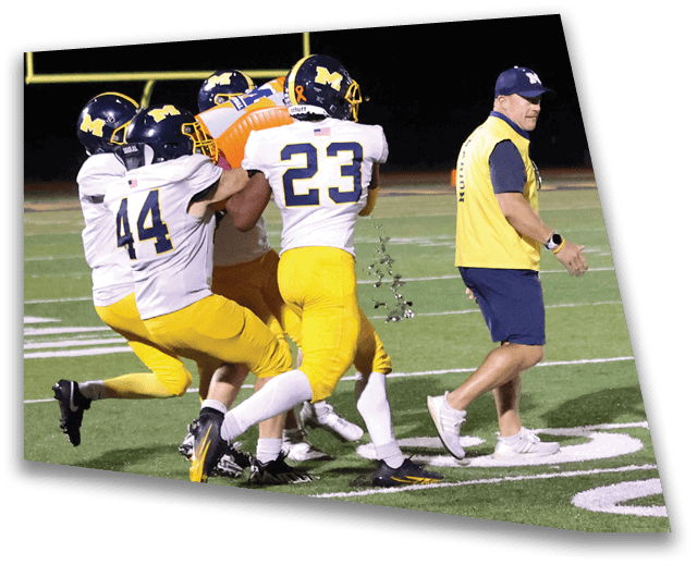 A group of football players are tackling each other on the field. AI generated content