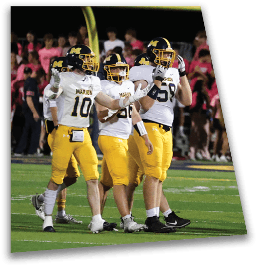 A group of football players wearing yellow and white uniforms are standing on a field. They are talking to each other and some are holding their helmets. AI generated content
