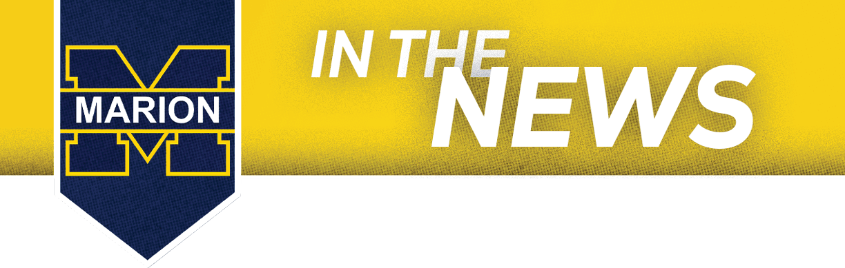 A blue and yellow sign that says “In the News" with a picture of a blue sky. AI generated content