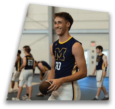 A group of young men are standing in a gym, wearing sports uniforms. One of the men is holding a football. AI generated content