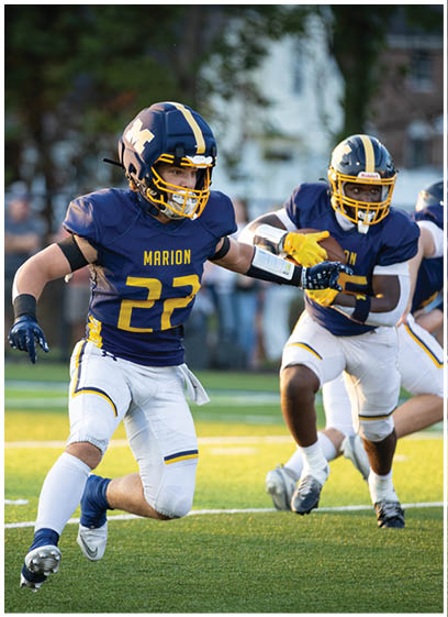 Two football players running on a field. AI generated content