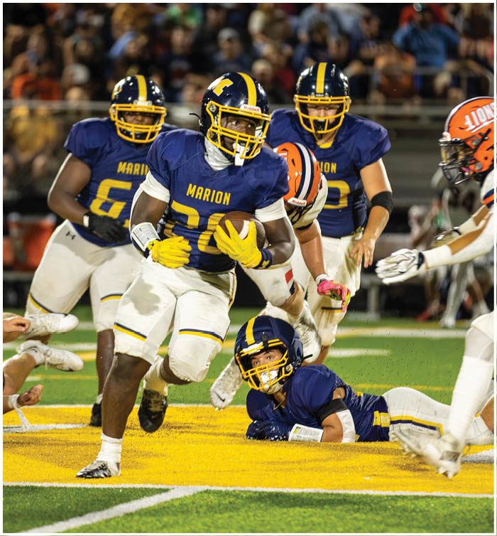 A group of football players on a field, one player is running with the ball while others are chasing him. AI generated content