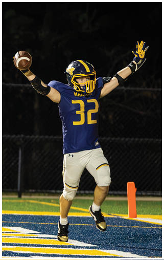 A football player wearing a blue jersey with the number 32 celebrates after scoring a touchdown. AI generated content