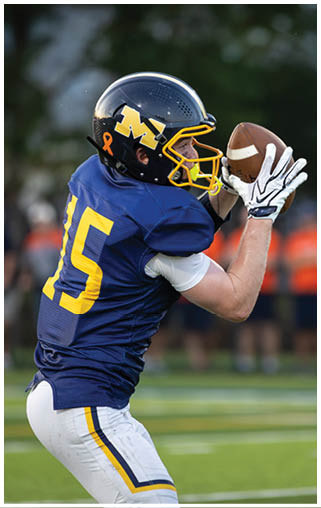 A football player wearing a blue and yellow jersey with the number 15 on it catching a football. AI generated content