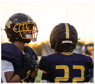 Three football players wearing blue uniforms and helmets. AI generated content