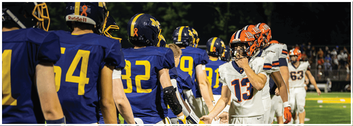 A group of football players in blue and yellow uniforms are standing on a field. AI generated content