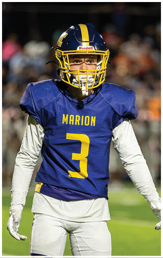 A football player wearing a blue and yellow jersey stands on a field. AI generated content