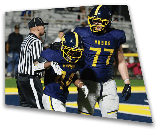 A football player wearing a blue jersey with the number 77 stands next to a referee on the field. AI generated content