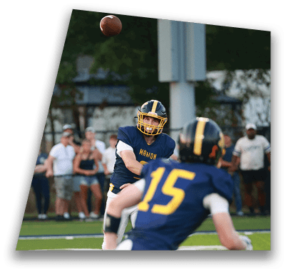 Two football players in blue uniforms are playing a game. One player is throwing a football while the other is running. AI generated content