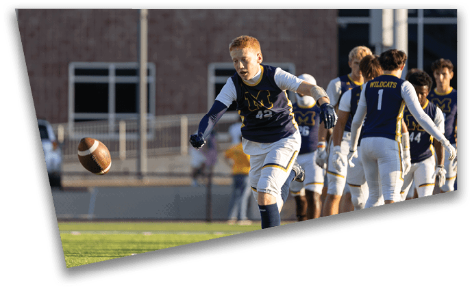 A boy in a football uniform is holding a football. AI generated content