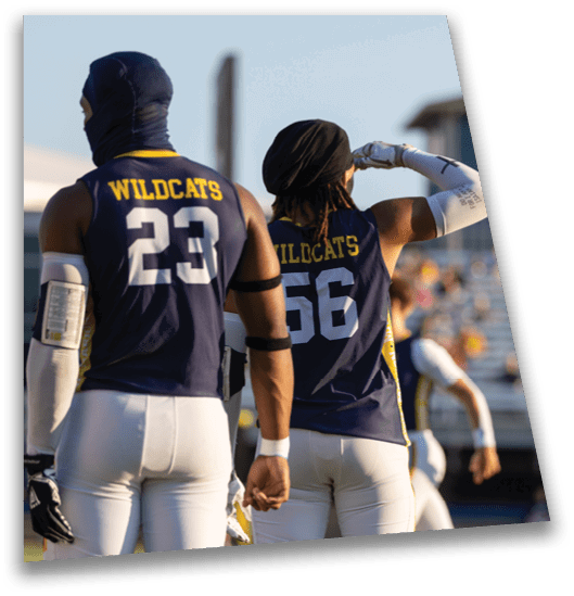 Two football players wearing blue and yellow uniforms stand on the field. AI generated content