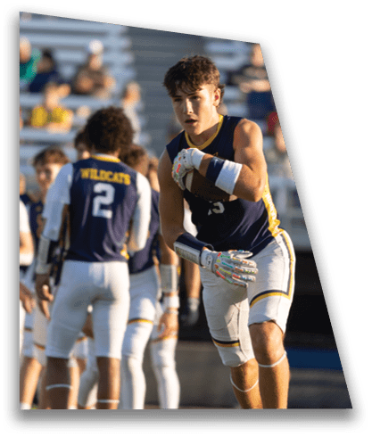 A group of young men are playing a game of football. One of the players is holding the ball in his hands. AI generated content