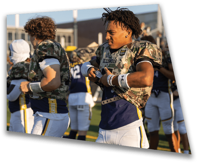 A group of football players wearing camouflage uniforms and holding their helmets. AI generated content